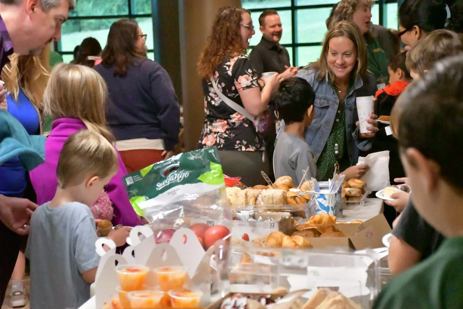 Students and families enjoying a welcome breakfast event